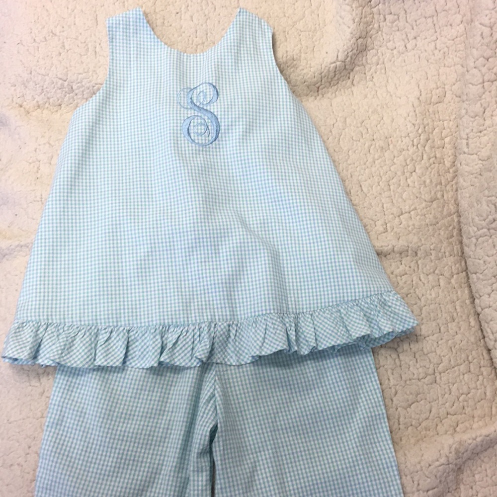 Blue and white outfit with S monogram.